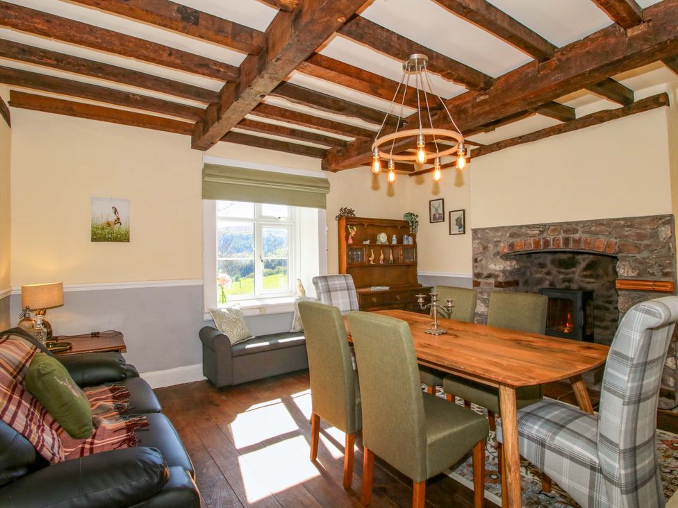 A dining room with a table and chairs at Beach Farmhouse in Bishops Castle