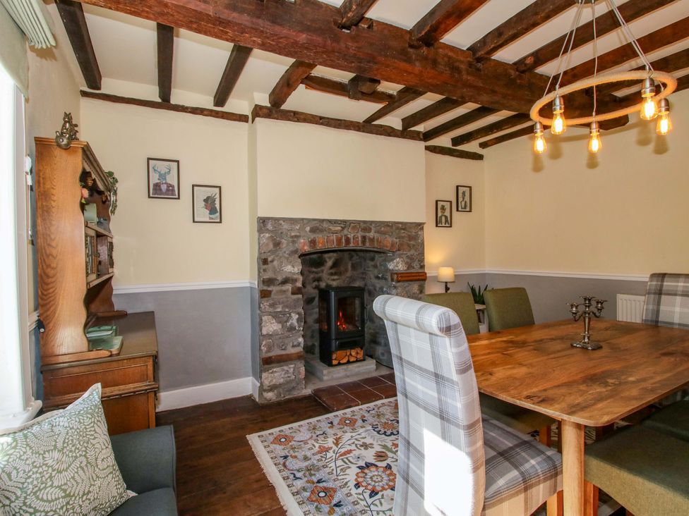 A dining room with a table and chairs at Beach Farmhouse in Bishops Castle