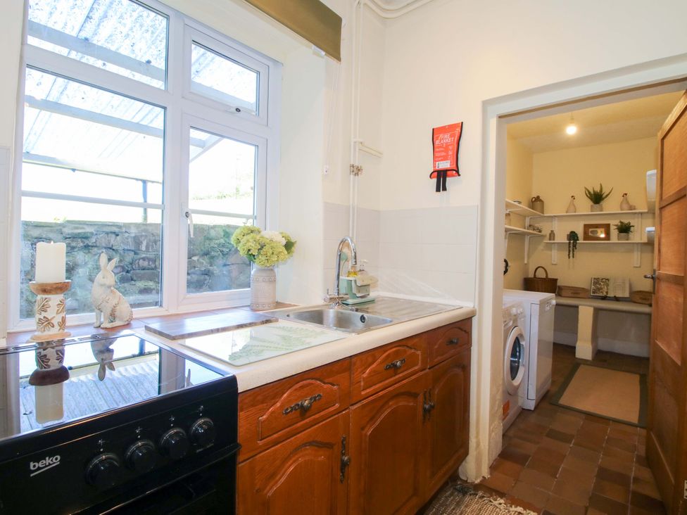 A kitchen with stove and sink at Beach Farmhouse in Bishops Castle