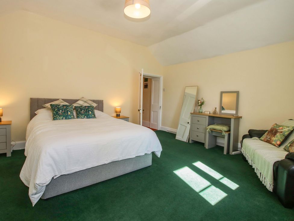 A bedroom with a bed and dresser at Beach Farmhouse in Bishops Castle