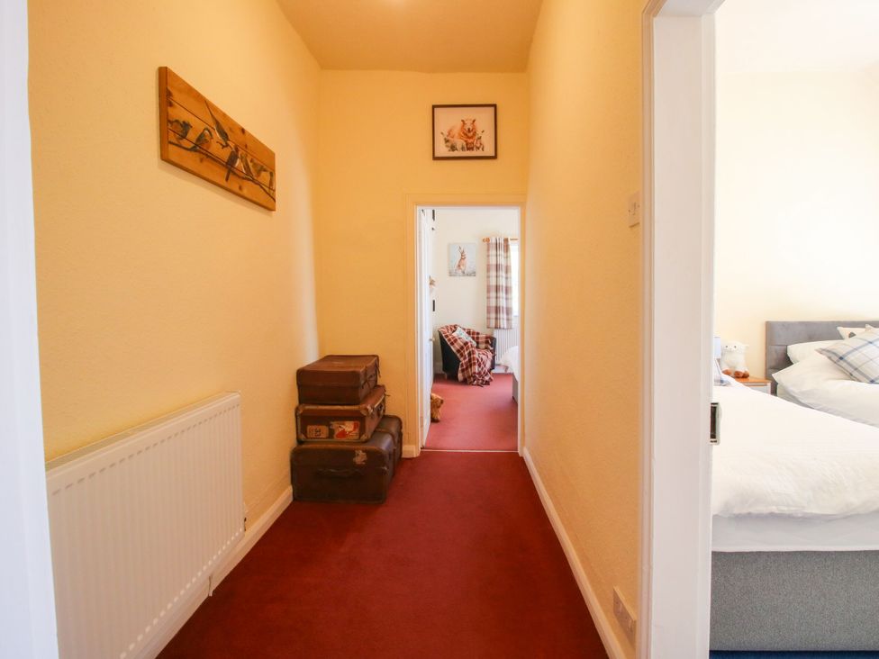 A hallway with doorways to rooms at Beach Farmhouse in Bishops Castle