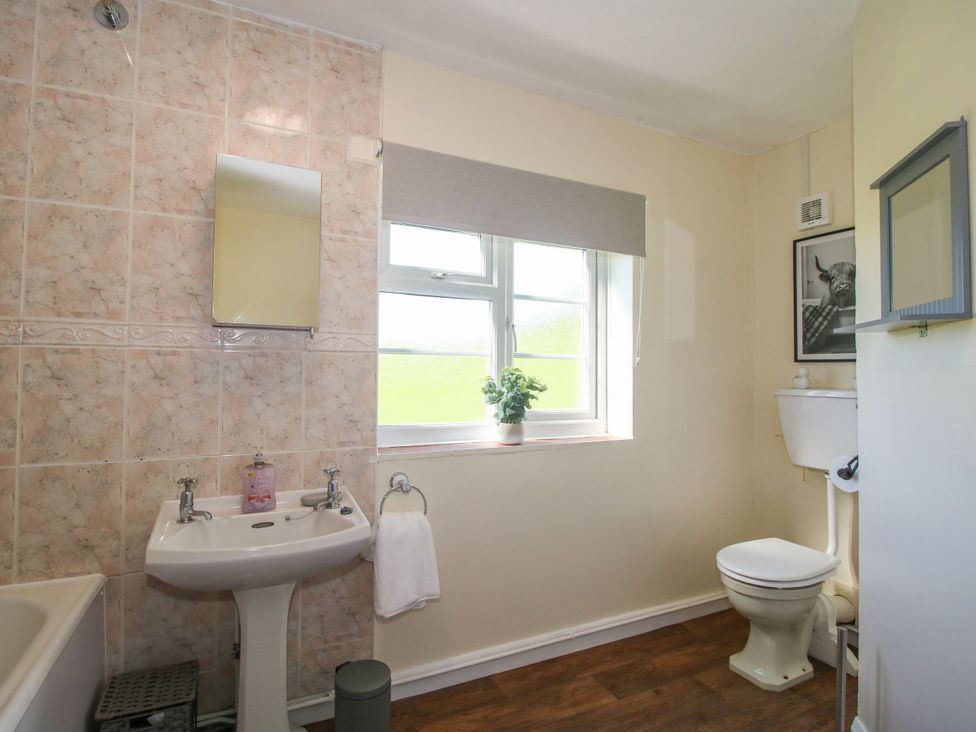 A bathroom with a sink and toilet at Beach Farmhouse in Bishops Castle