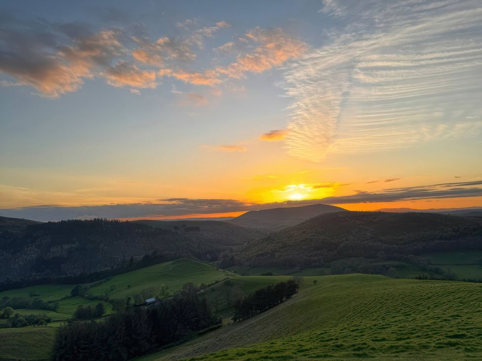 A scenic view of hills during sunset at Beach Farmhouse near Bishop's Castle