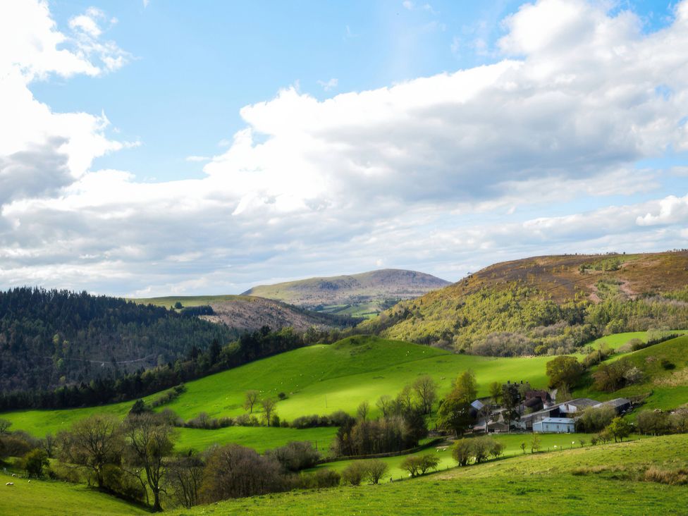 A landscape featuring mountains and fields at Beach Farmhouse near Bishop's Castle