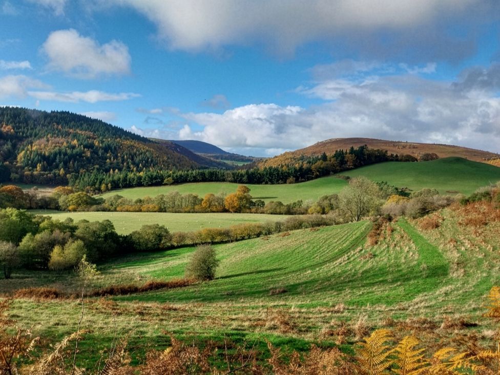 A scenic view of fields and hills at Beach Farmhouse near Bishop's Castle