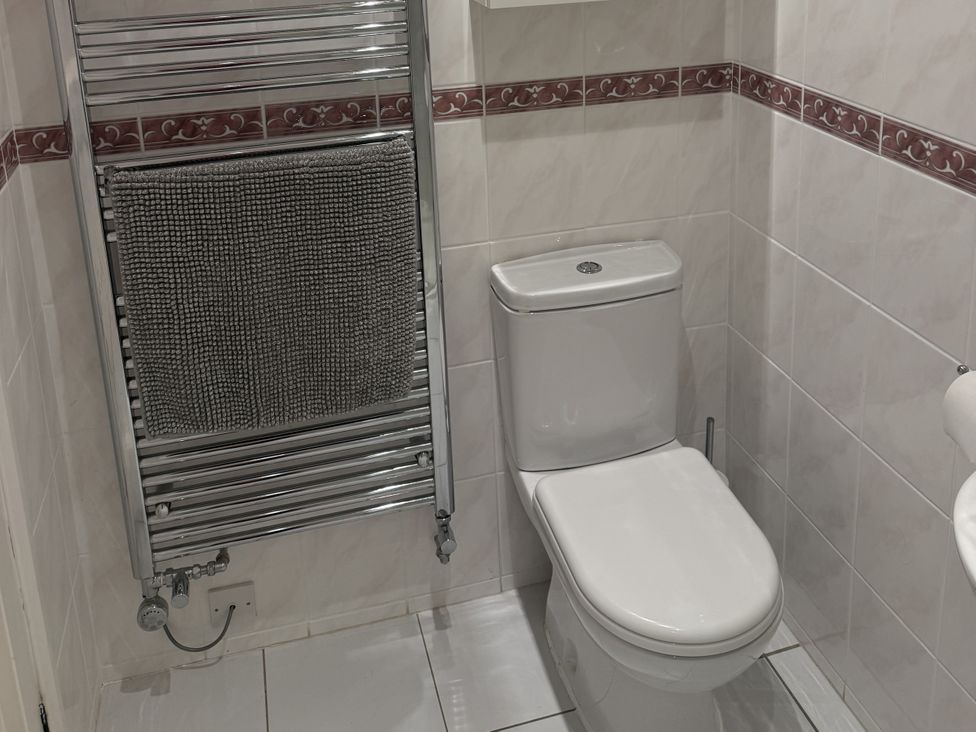 A bathroom with a toilet and towel radiator at The Forge Marksbury near Farmborough