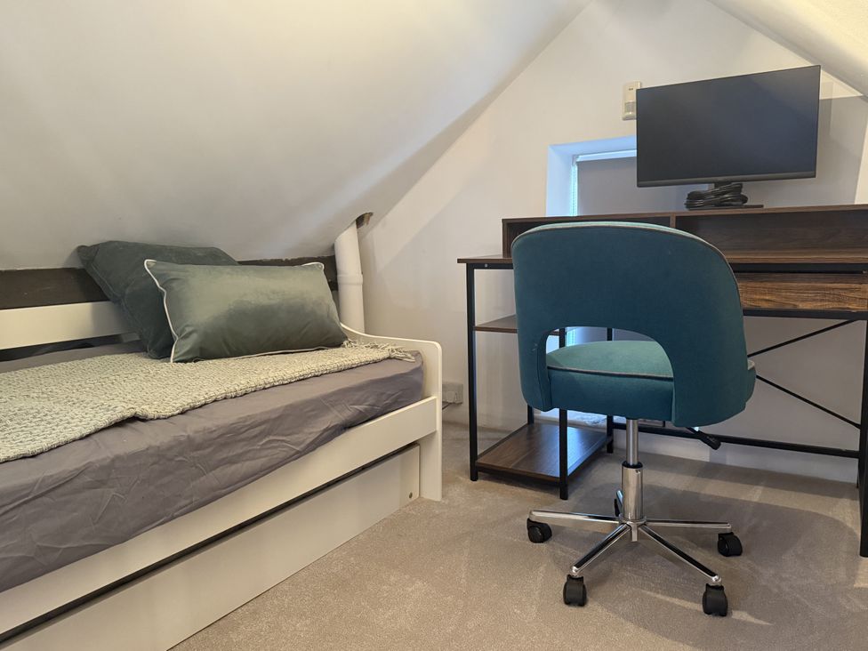 A bedroom with a bed and desk at The Forge in Marksbury near Farmborough