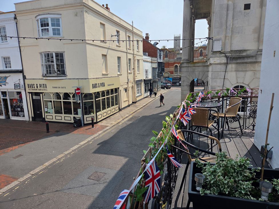 An outdoor view of a restaurant and street at Harbour Retreat in Weymouth