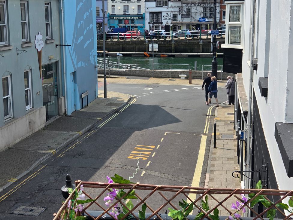 A street scene with pedestrians and waterfront at Harbour Retreat in Weymouth
