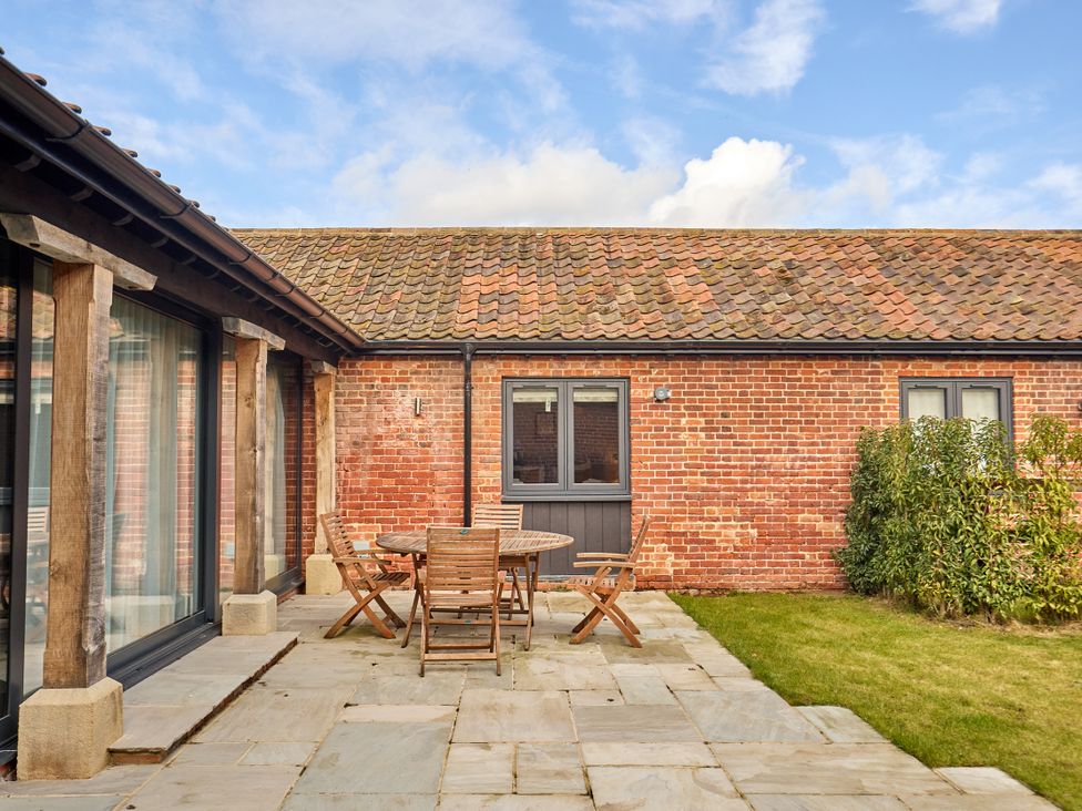An outdoor area with a table and chairs at The Saddlery in Norwich