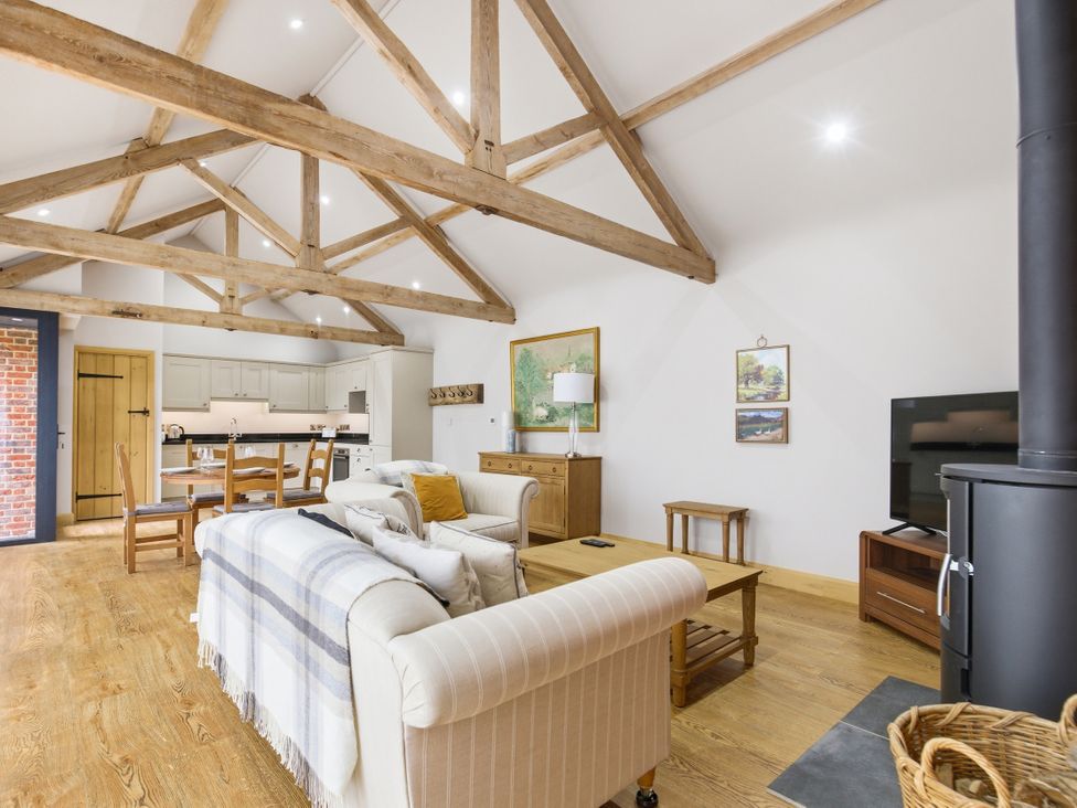 A living room with a sofa and table at The Saddlery in Norwich