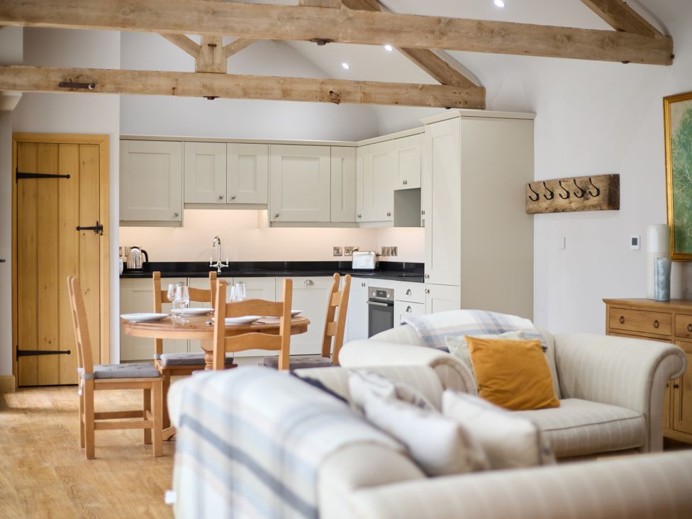A kitchen with a dining table and chairs at The Saddlery in Norwich
