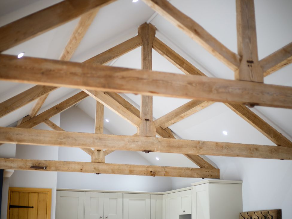 A kitchen with exposed roof beams at The Saddlery in Norwich