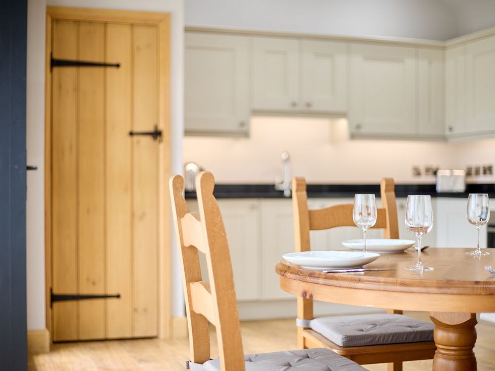 A kitchen with a table set for dining at The Saddlery in Norwich