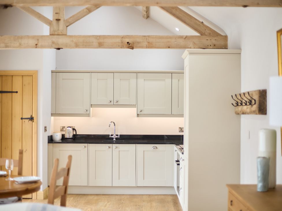 A kitchen with cabinets and a sink at The Saddlery in Norwich