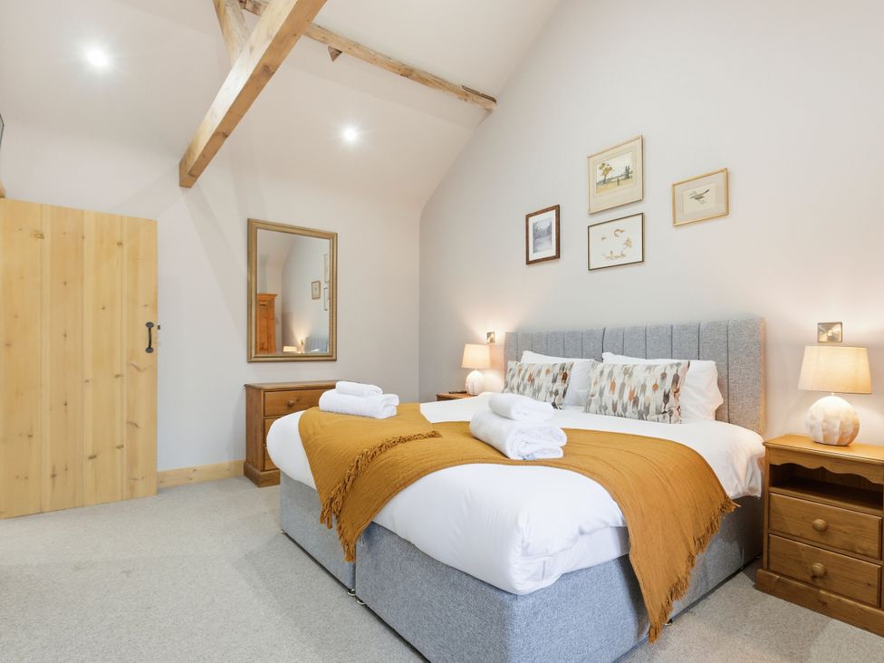 A bedroom with bed and furniture at The Saddlery in Norwich