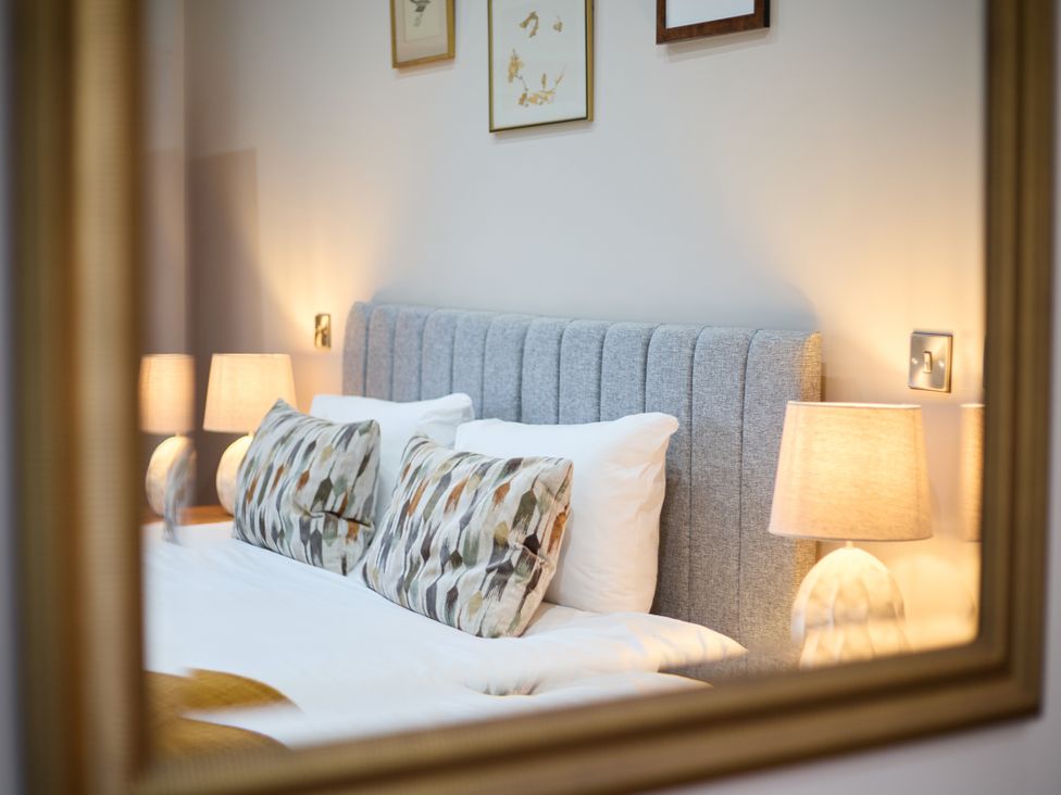 A bedroom with a bed and lamps at The Saddlery in Norwich