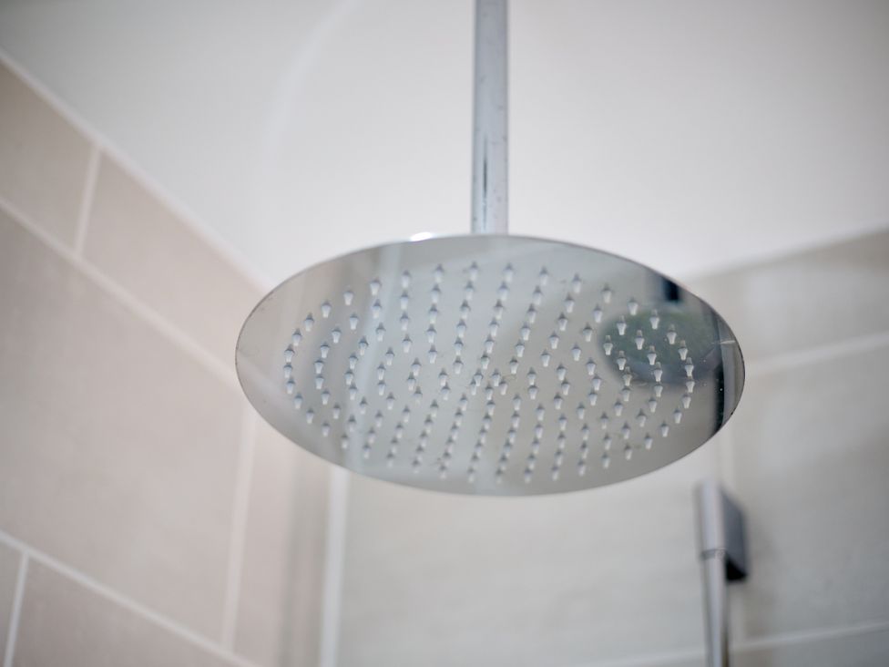 A shower head in a bathroom at The Saddlery Norwich