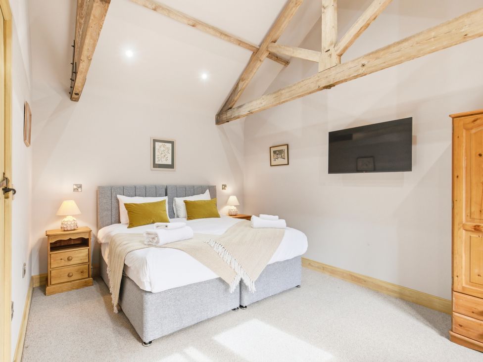 A bedroom with a bed and wardrobe at The Saddlery in Norwich