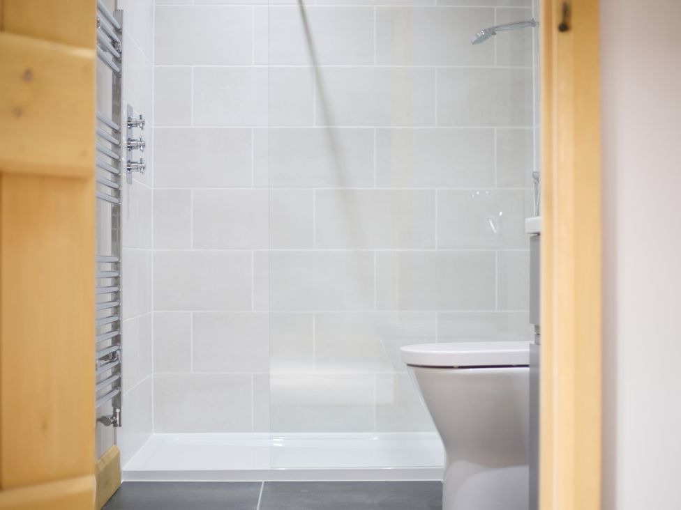 A bathroom with a toilet and shower at The Saddlery in Norwich