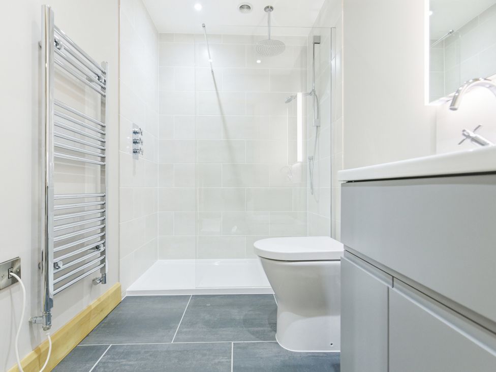 A bathroom with a shower, toilet and sink at The Saddlery in Norwich