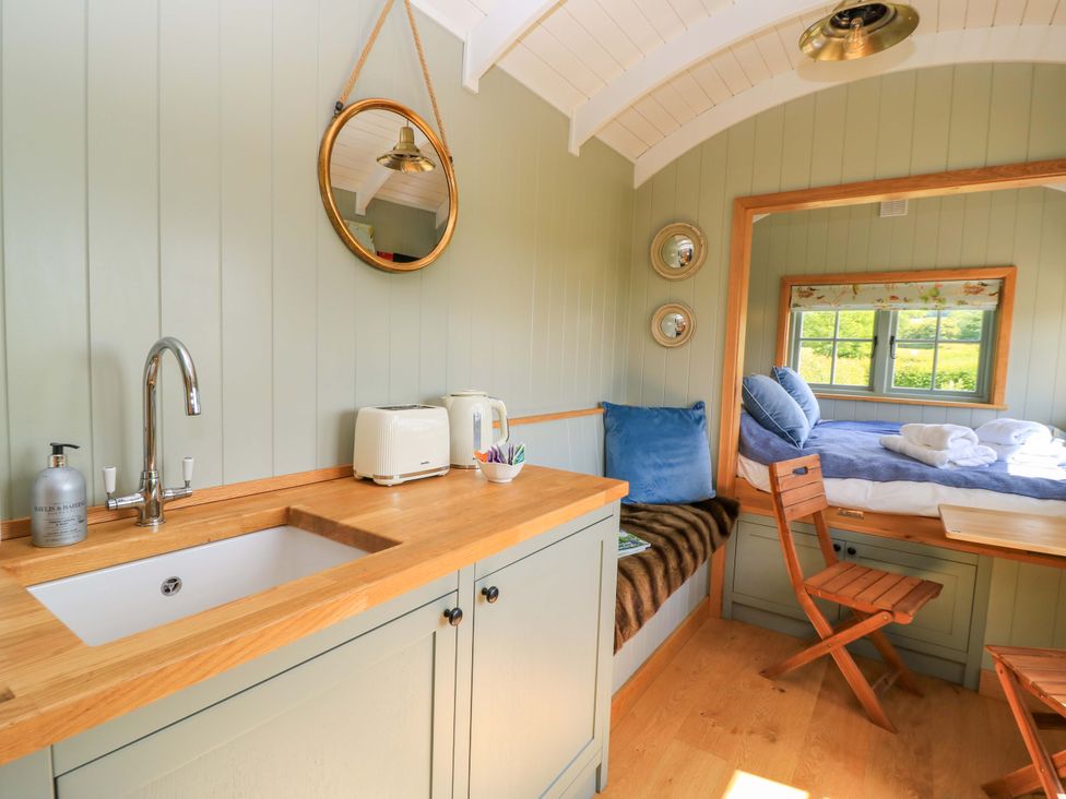 A kitchen area with a sink and toaster at Goose Whistle Hut in Foxham