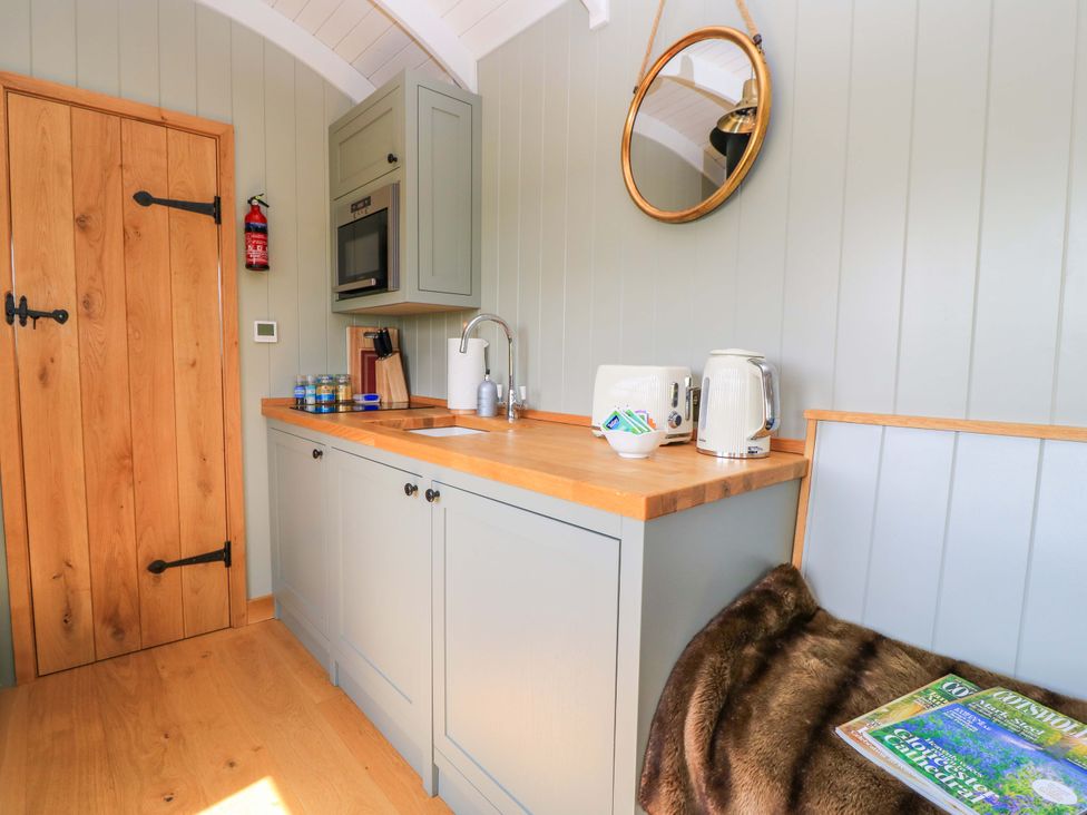 A kitchen with cabinets and appliances at Goose Whistle Hut in Foxham