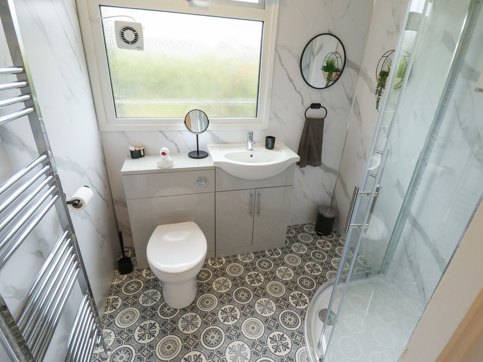 A bathroom with a shower and sink at Orby Cottage in Chapel St Leonards