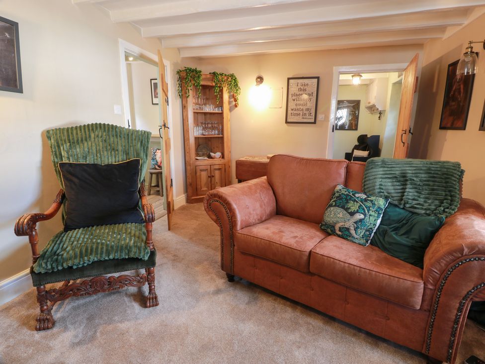 A living room with a sofa and armchair at Rowantree Cottage in Kelso