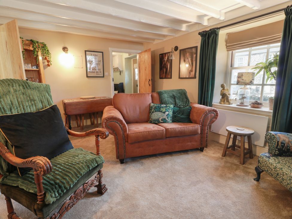 A living room with seating and a window at Rowantree Cottage in Kelso