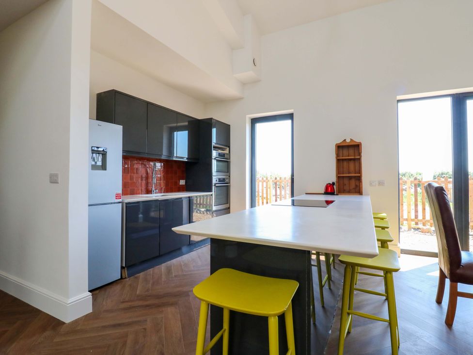 A kitchen with a refrigerator, cabinets, and a kitchen island at Little Yeat Farm (4 Bed/2 Bath) Aylesbury