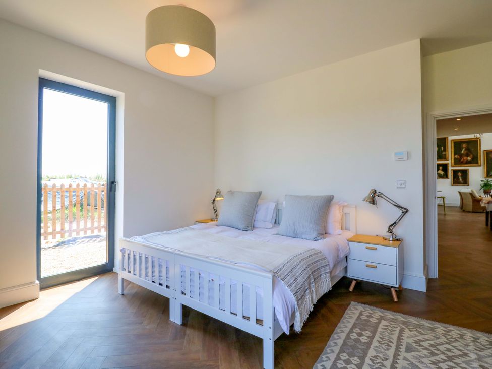 A bedroom with a bed and nightstand at Little Yeat Farm (4 Bed/2 Bath) Aylesbury