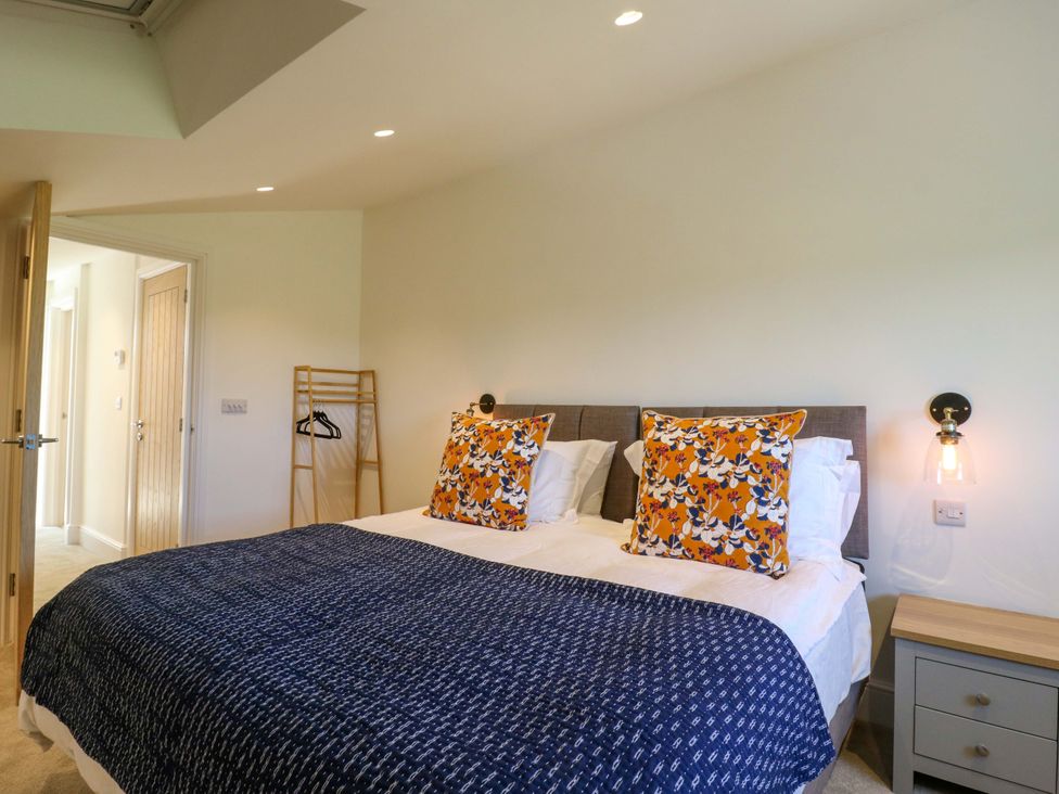 A bedroom with a bed and bedside table at Little Yeat Farm (4 Bed/2 Bath) Aylesbury