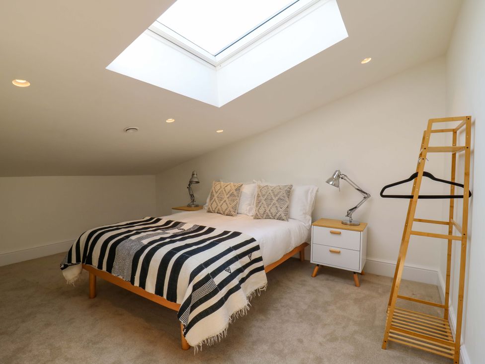 A bedroom with a skylight and a bed at Little Yeat Farm (4 Bed/2 Bath) in Aylesbury