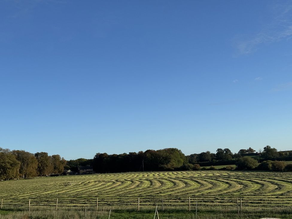 A field with mowed hay patterns at Number 3 The Barn House in Woodham