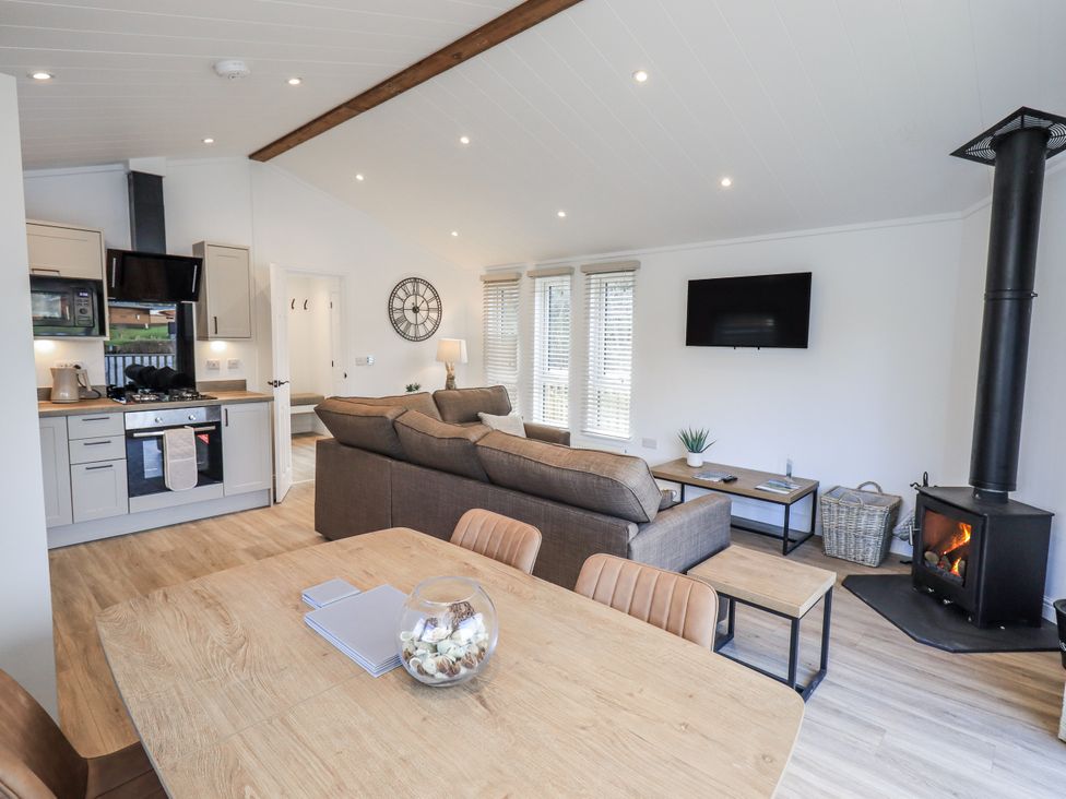A living room with a sofa and dining table at Lakeside Lodge Bowland Lakes Leisure Village near Garstang