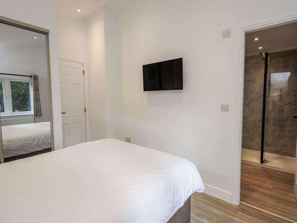 A bedroom with a bed and a television at Lakeside Lodge near Bowland Lakes Leisure Village