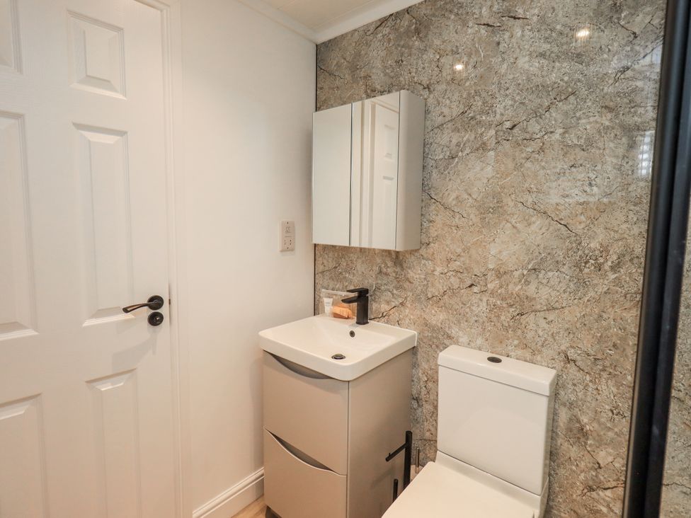 A bathroom with a sink and toilet at Lakeside Lodge near Bowland Lakes Leisure Village