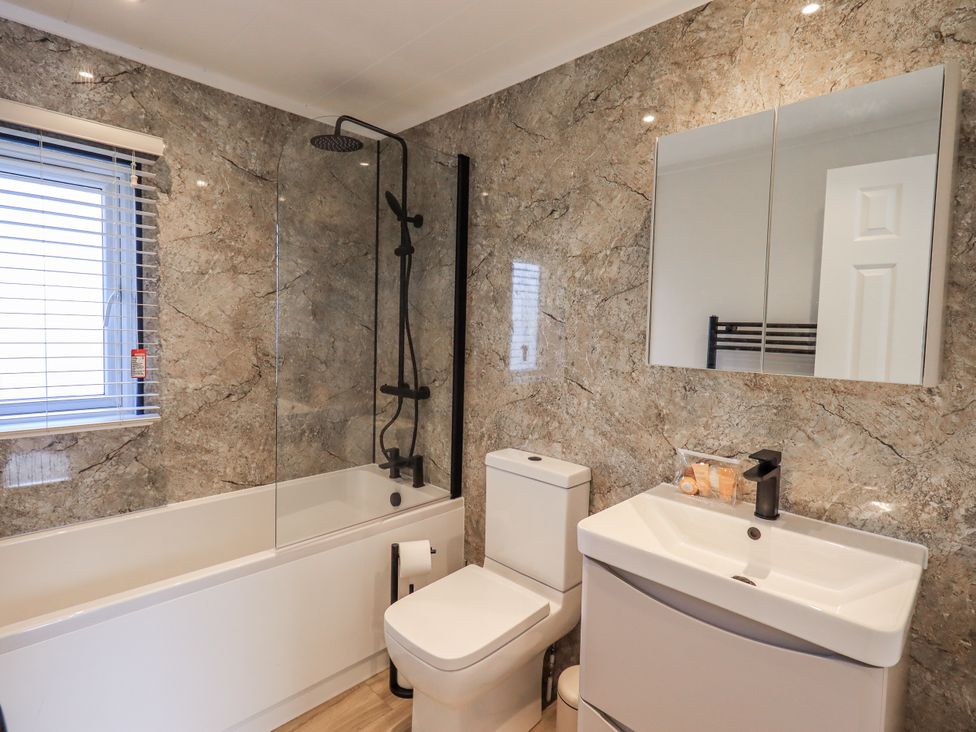A bathroom with a bathtub, shower, sink, and toilet at Lakeside Lodge Bowland Lakes Leisure Village near Garstang