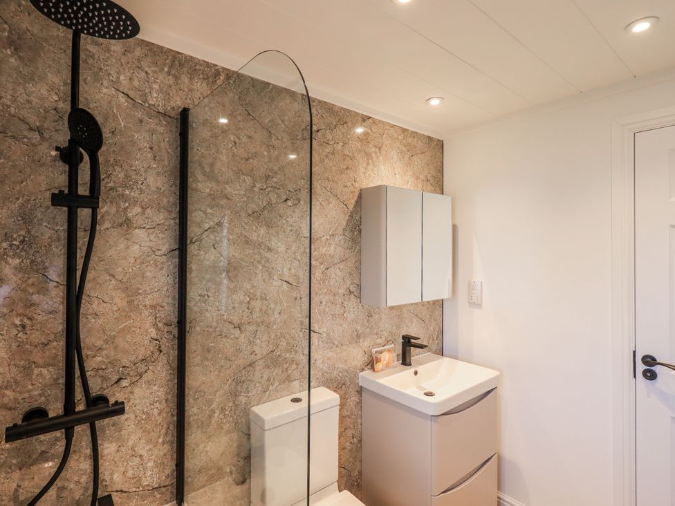 A bathroom with a shower, toilet, and sink at Lakeside Lodge Bowland Lakes Leisure Village near Garstang