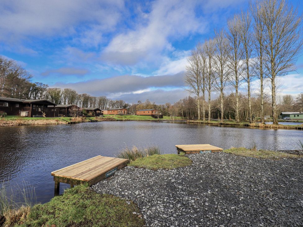 An outdoor space with water and wooden platforms at Lakeside Lodge Bowland Lakes Leisure Village near Garstang