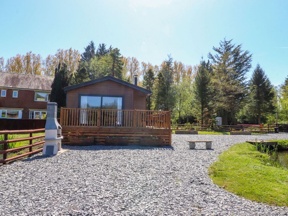 An outdoor view of a house with a deck and gravel area at Lakeside Lodge Bowland Lakes Leisure Village near Garstang