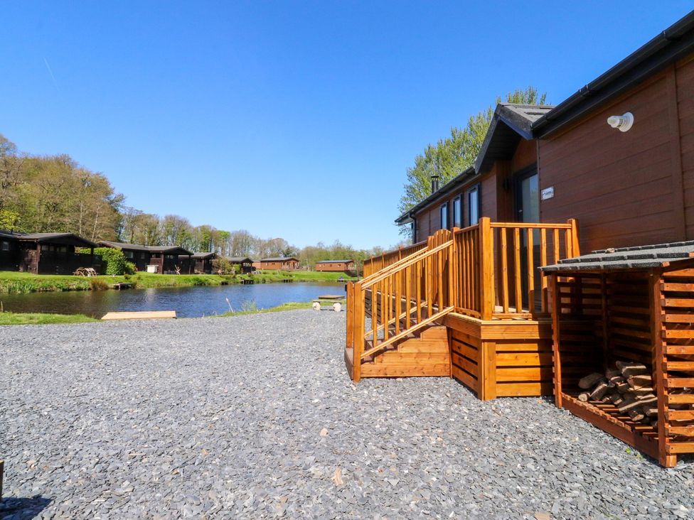 An outdoor area with wooden stairs and a lake at Lakeside Lodge in Bowland Lakes Leisure Village near Garstang