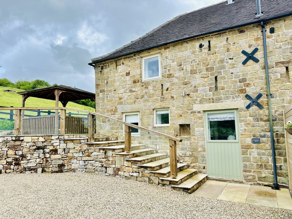 An outdoor area with a stone building and steps at Parlour Barn in Leek