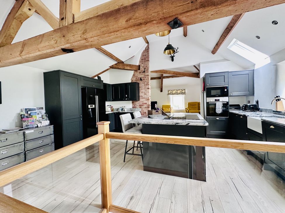 A kitchen with cabinets and appliances at Parlour Barn in Leek