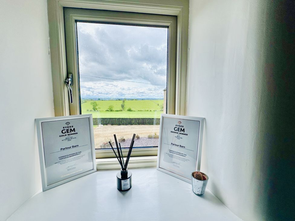 A window with awards and decorative items at Parlour Barn in Leek