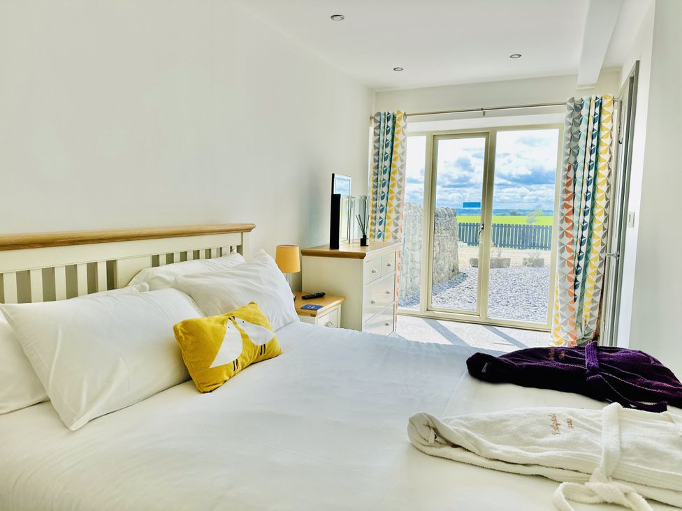 A bedroom with a bed and a television at Parlour Barn in Leek