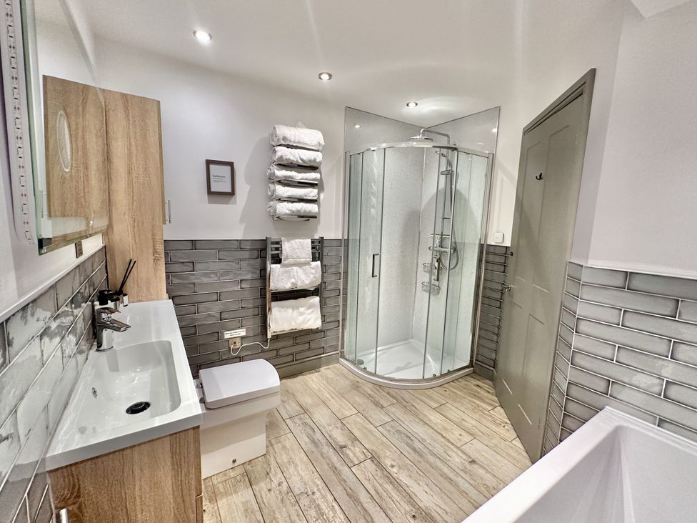 A bathroom with a shower, sink, and toilet at Parlour Barn in Leek