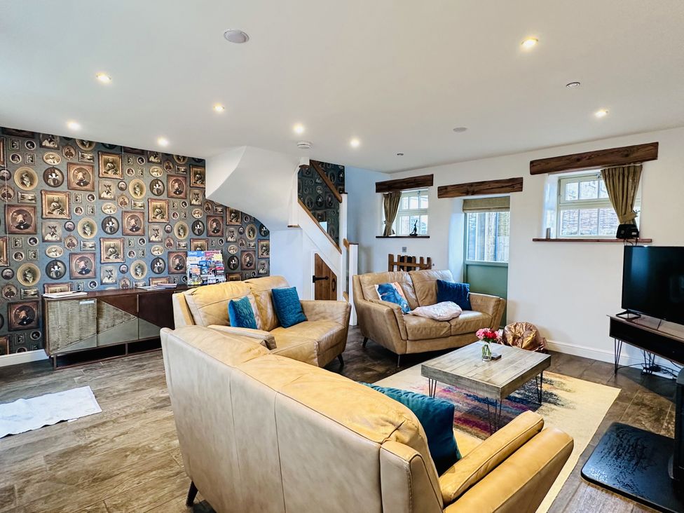 A living room with sofas and a coffee table at Pastures Barn in Bradnop near Leek