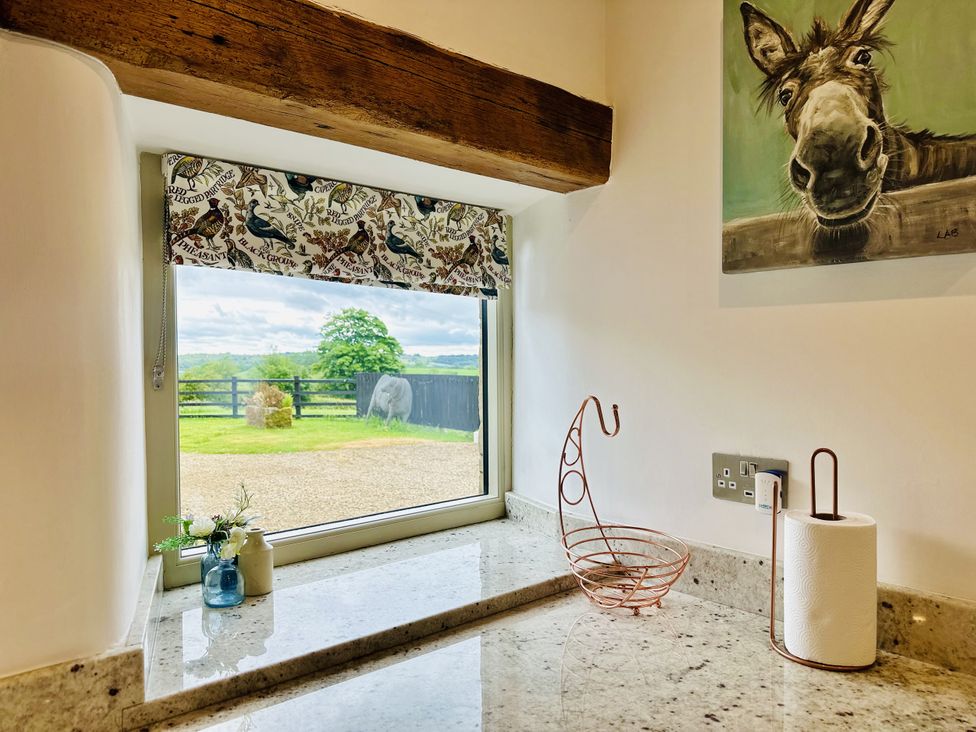 A kitchen window with outdoor view at Pastures Barn Bradnop near Leek